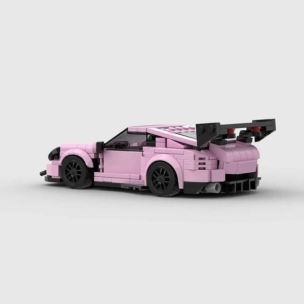 Vue de profil de la Porsche GT3 RS rose en briques, montrant la longueur et les détails du modèle.