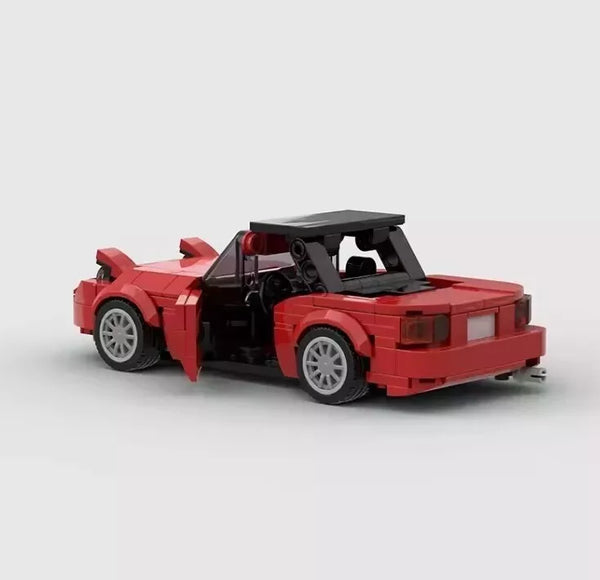 Vue de trois-quarts arrière de la voiture Mazda MX-5 Miata en briques.