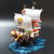 navire des Mugiwara One Piece, voiles blanches et lion doré