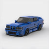 Kit de construction d'une BMW M3 E36 jaune en briques, montrant la vue de trois-quarts avant.